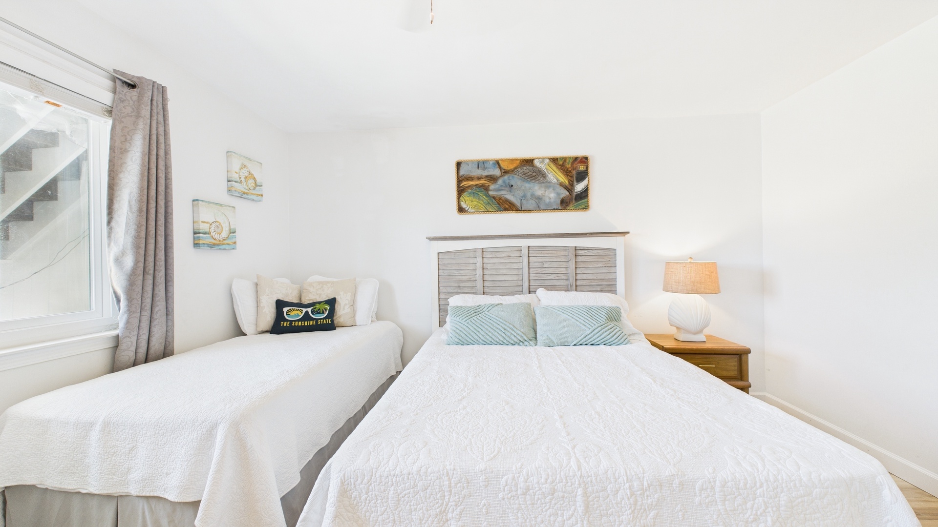 Guest bedroom with twin and queen beds TV and desk