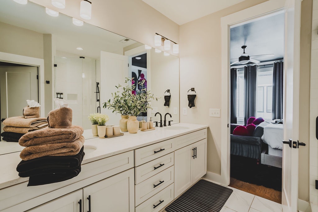 Primary bathroom with dual vanity and walk in shower