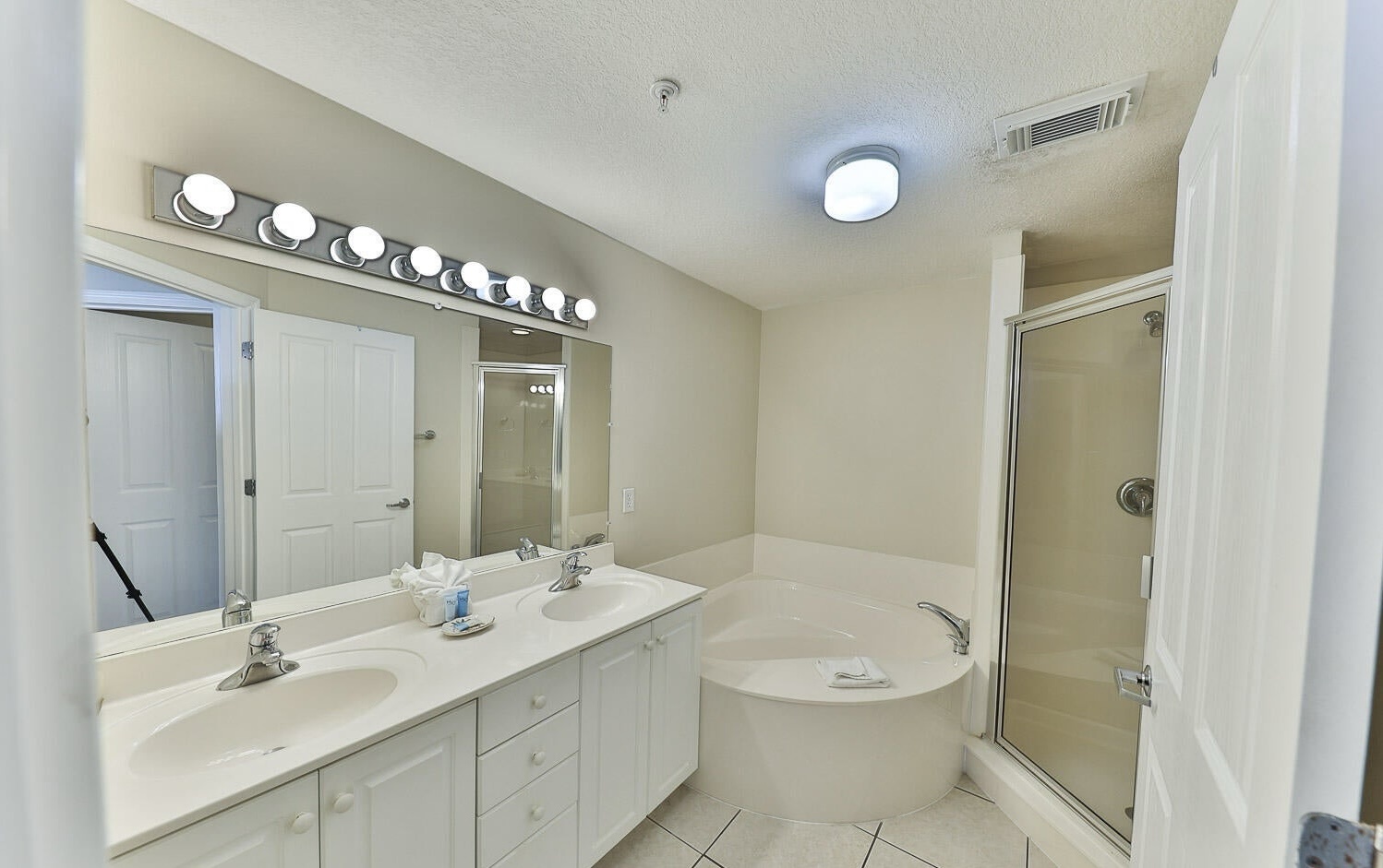 Master bathroom with dual vanity sink bathtub and walk in shower