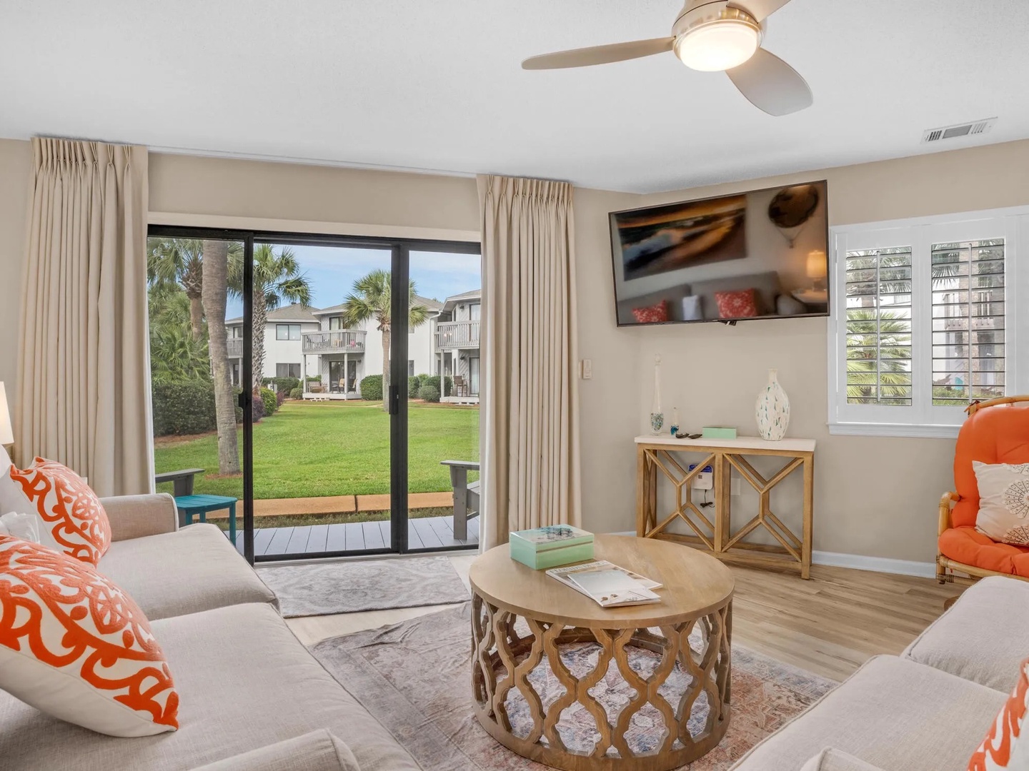 Open concept living area with stylish furniture, TV, and tons of natural light. Features a queen size sleeper sofa.