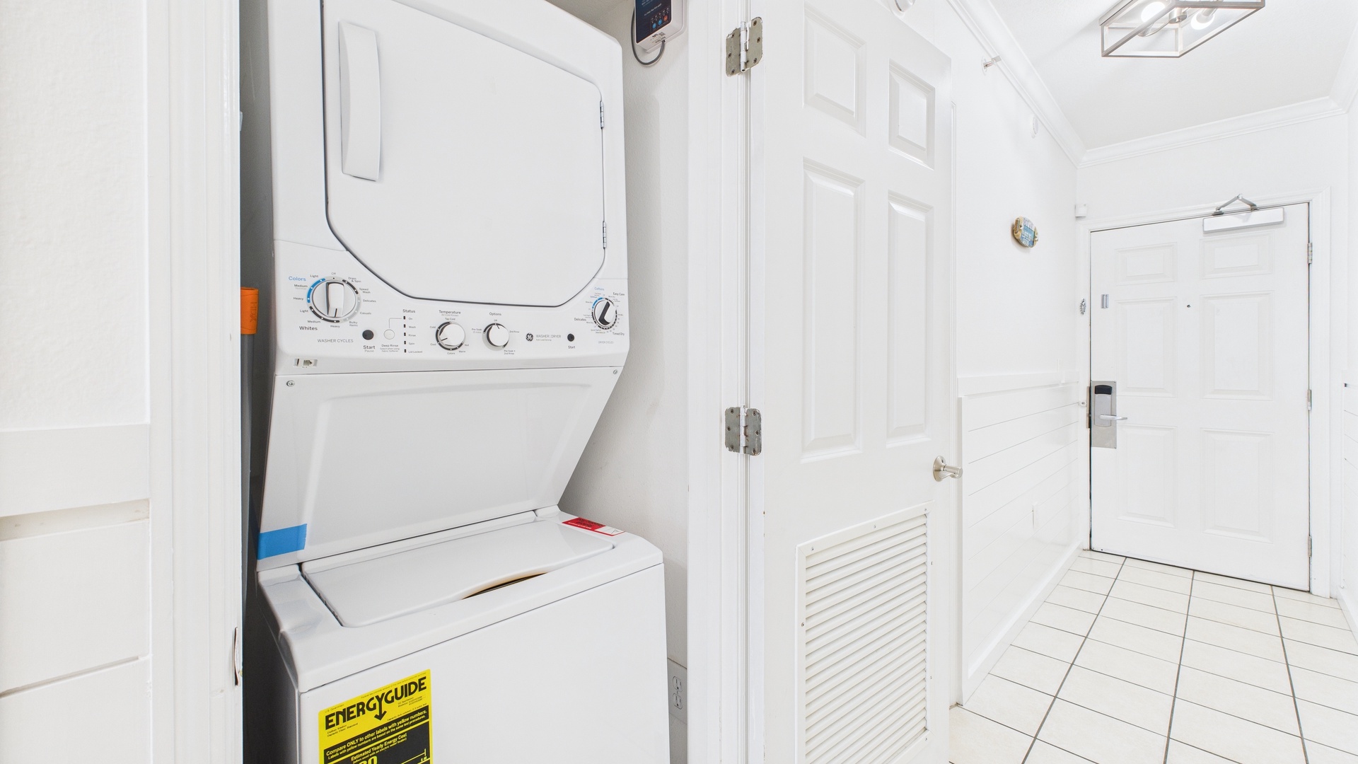 Washer and dryer machines in hallway closet