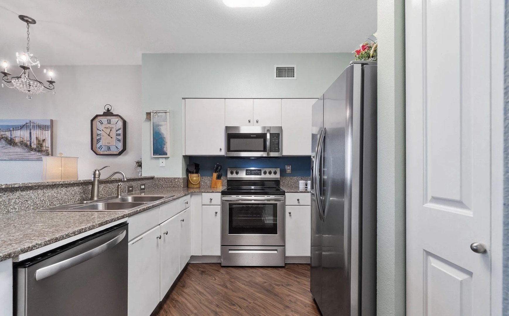 Full kitchen with stainless steel appliances and equipped with basic cooking essentials.