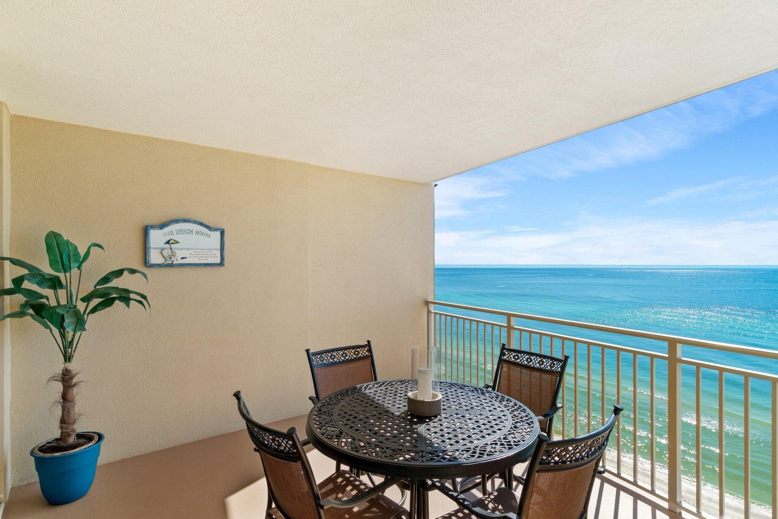 Balcony with dining table and coastal views
