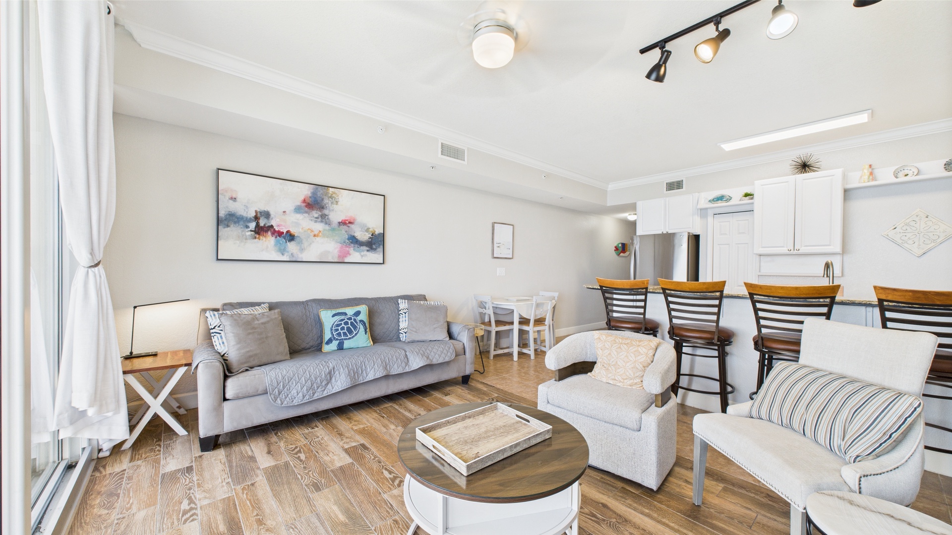 Open concept living area with stylish furnishings TV and sleeper sofa