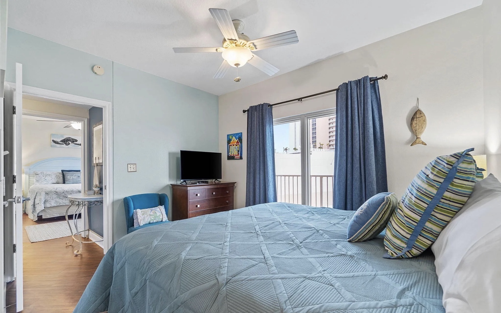 Second bedroom with king bed, TV, and scenic views.