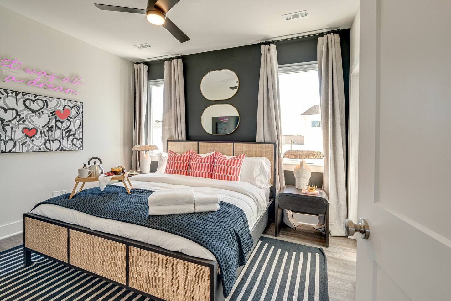5629 - Primary bedroom with King bed, designer furnishings, smart TV, and ensuite bathroom.