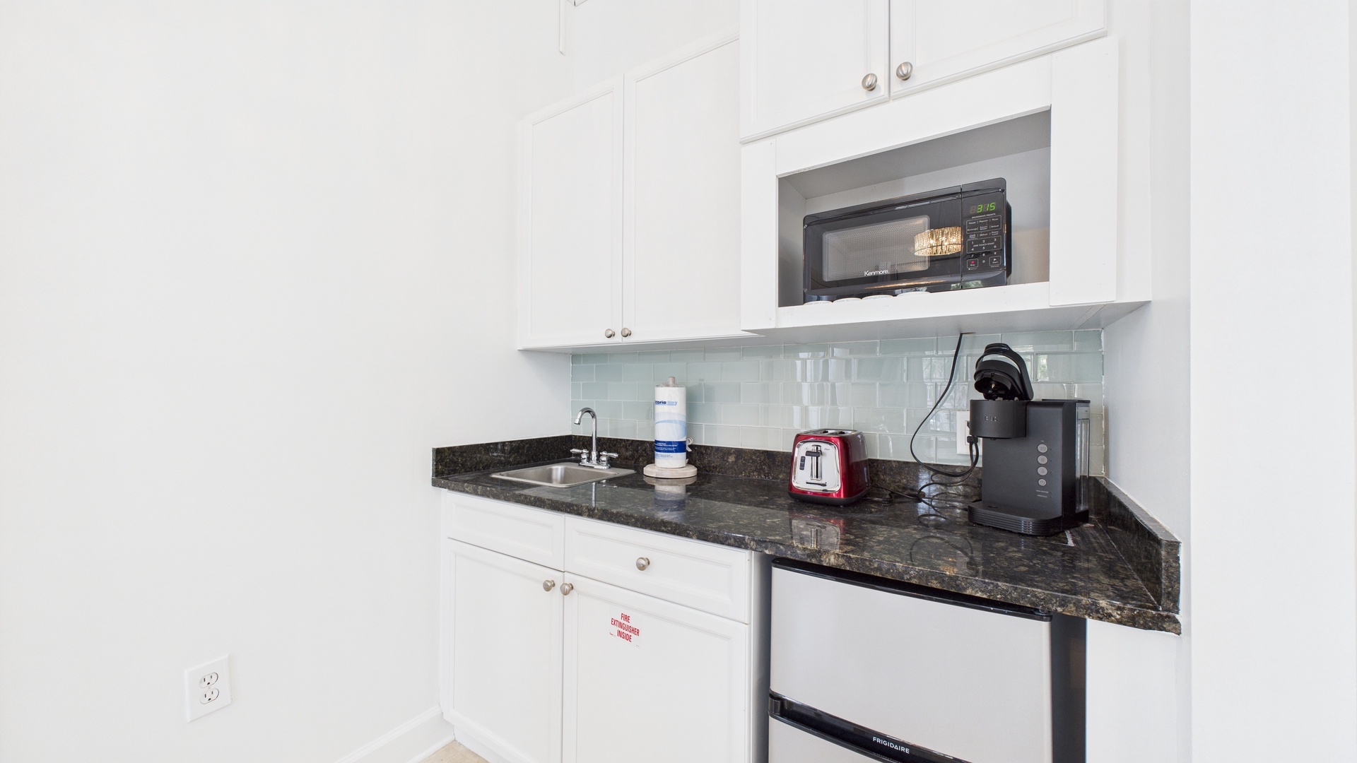 Kitchenette equipped with microwave mini fridge and coffee maker