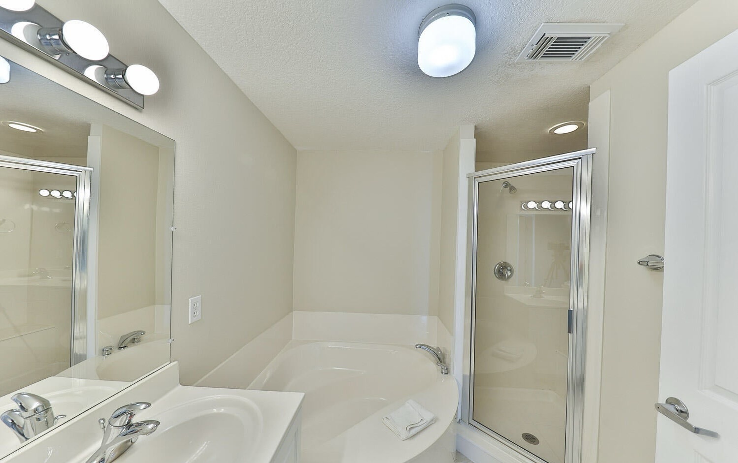 Master bathroom with dual vanity sink bathtub and walk in shower