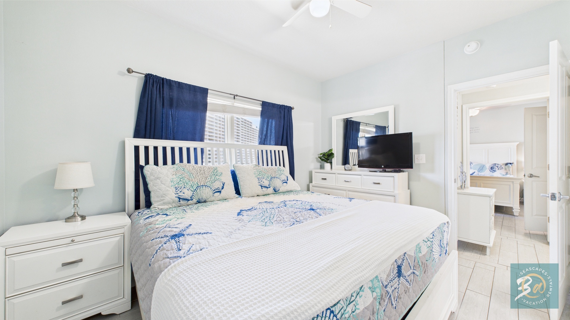 Guest bedroom with queen bed TV and ensuite bathroom