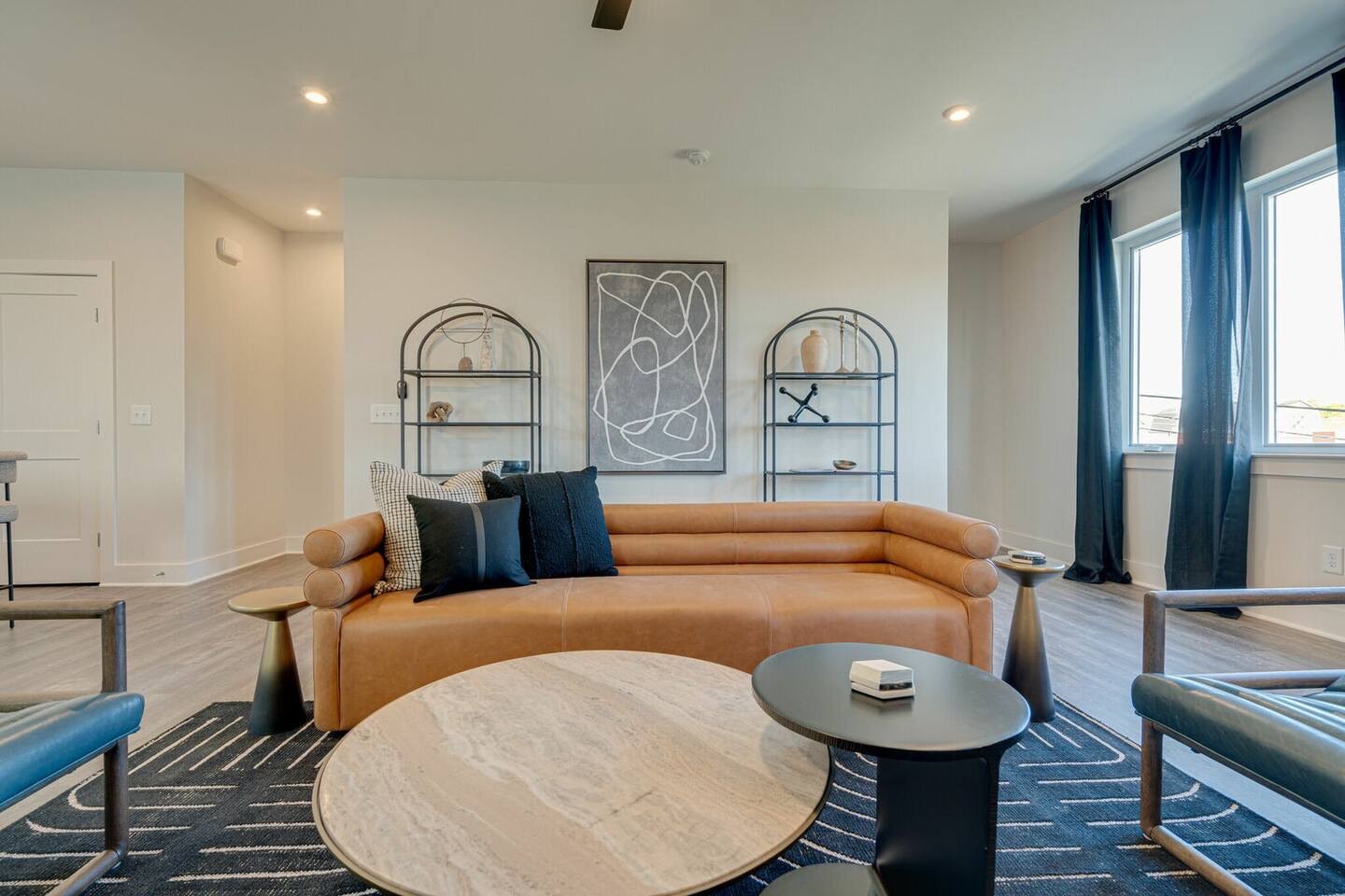 5627 - Open concept living area with stylish furnishings and smart TV.