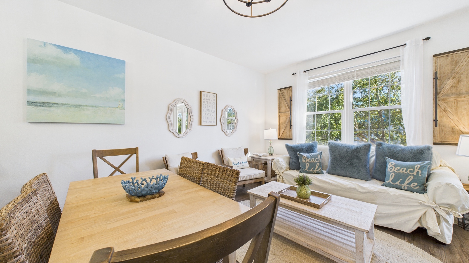 Open concept living area with TV and balcony access