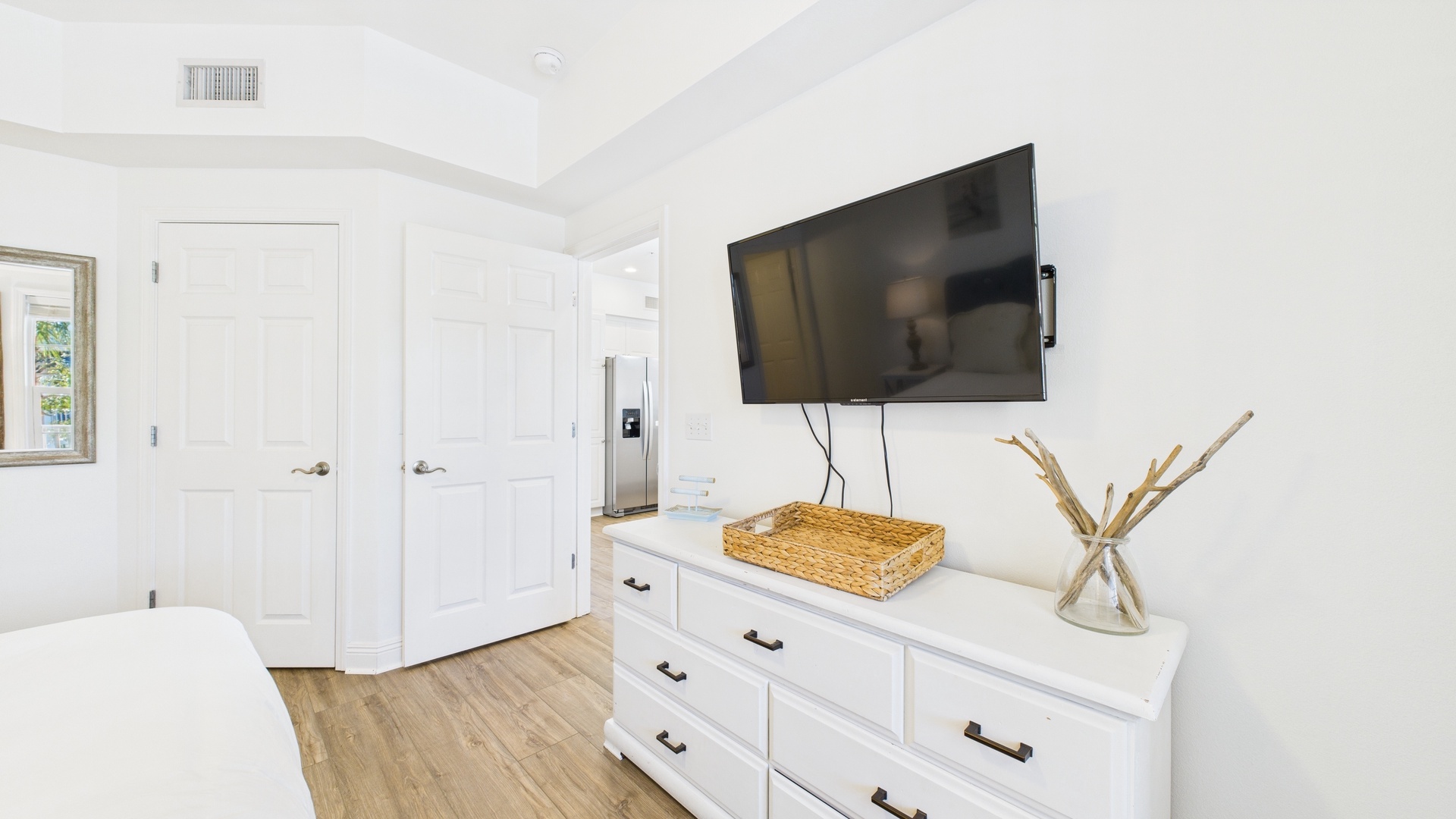 Primary bedroom with king bed TV and ensuite bathroom