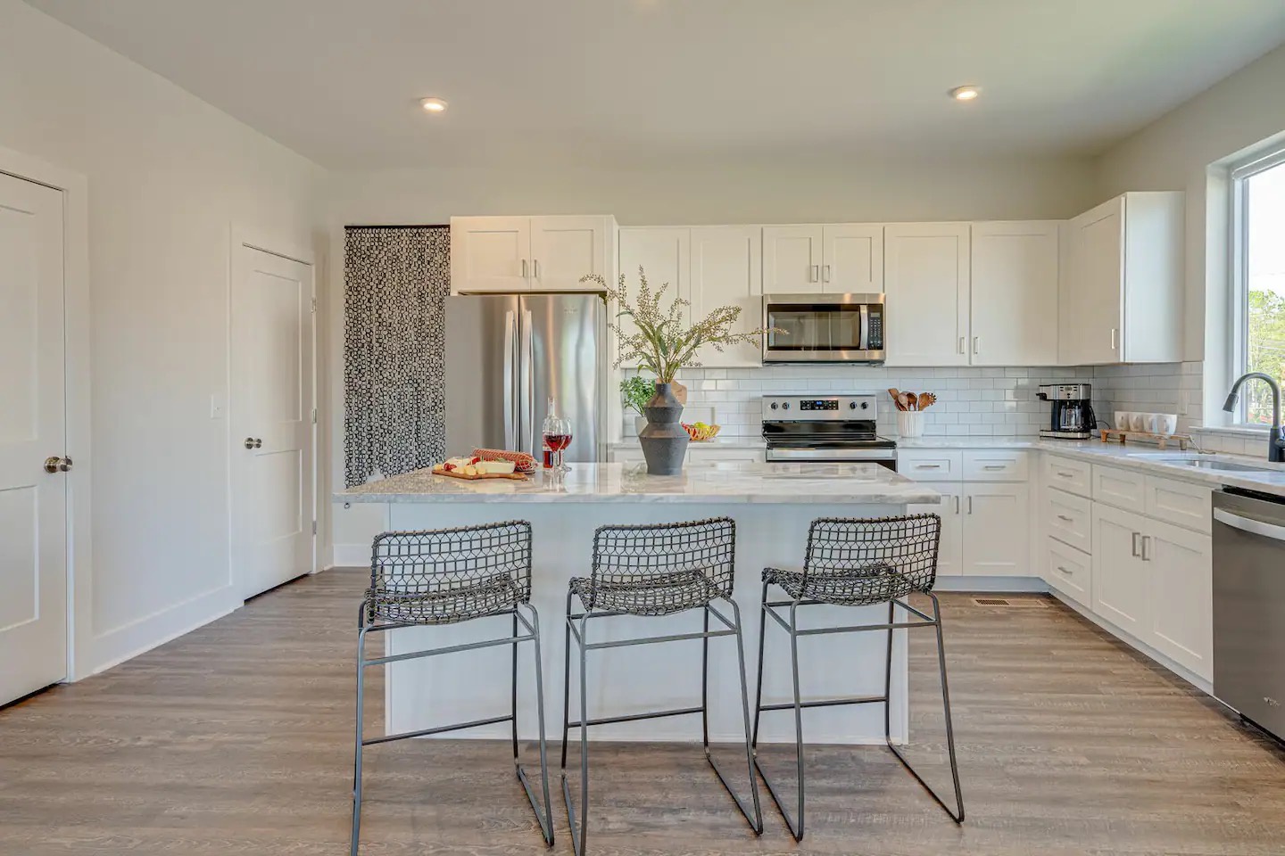 5631 - Fully equipped kitchen stocked with basic cooking essentials and stainless steel appliances.