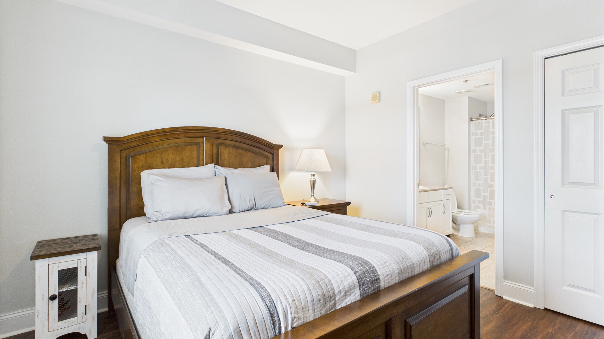 Primary guest bedroom with queen bed and ensuite bathroom (sleeps 2)