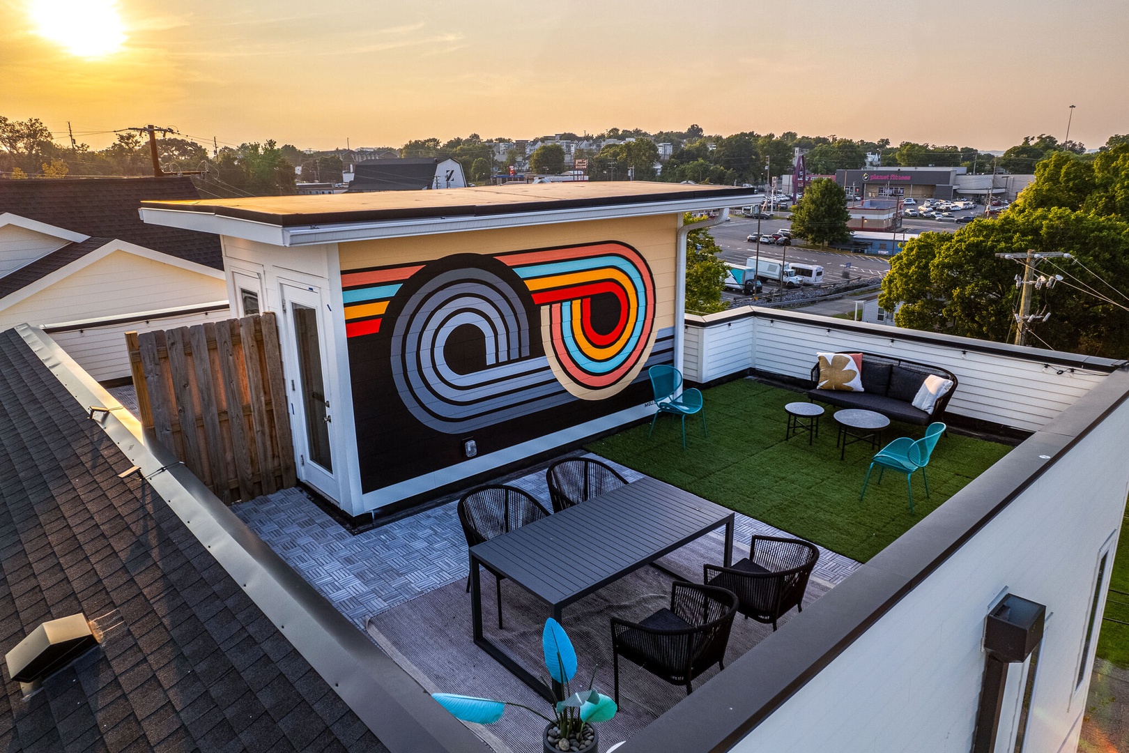 Private rooftop deck outdoor dining table (seats 4) and lounge area. Entire space is lined with bistro lights and includes a photo op mural!