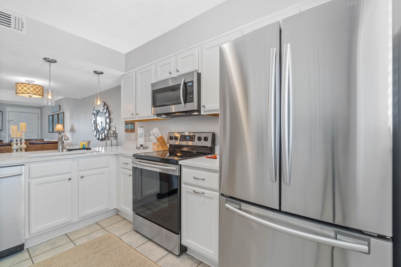 Kitchen with full amenities over looking the living room