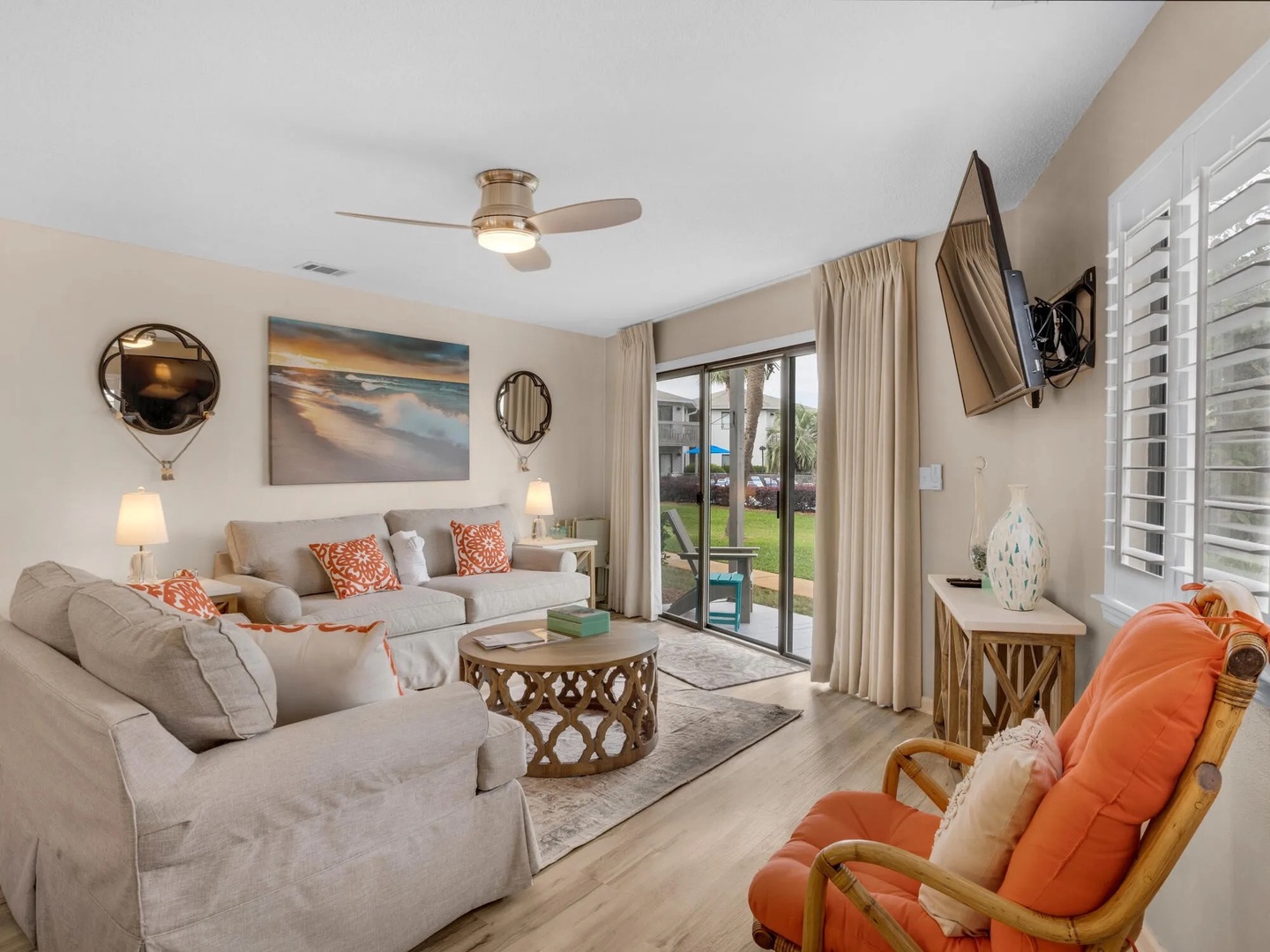 Open concept living area with stylish furniture, TV, and tons of natural light. Features a queen size sleeper sofa.