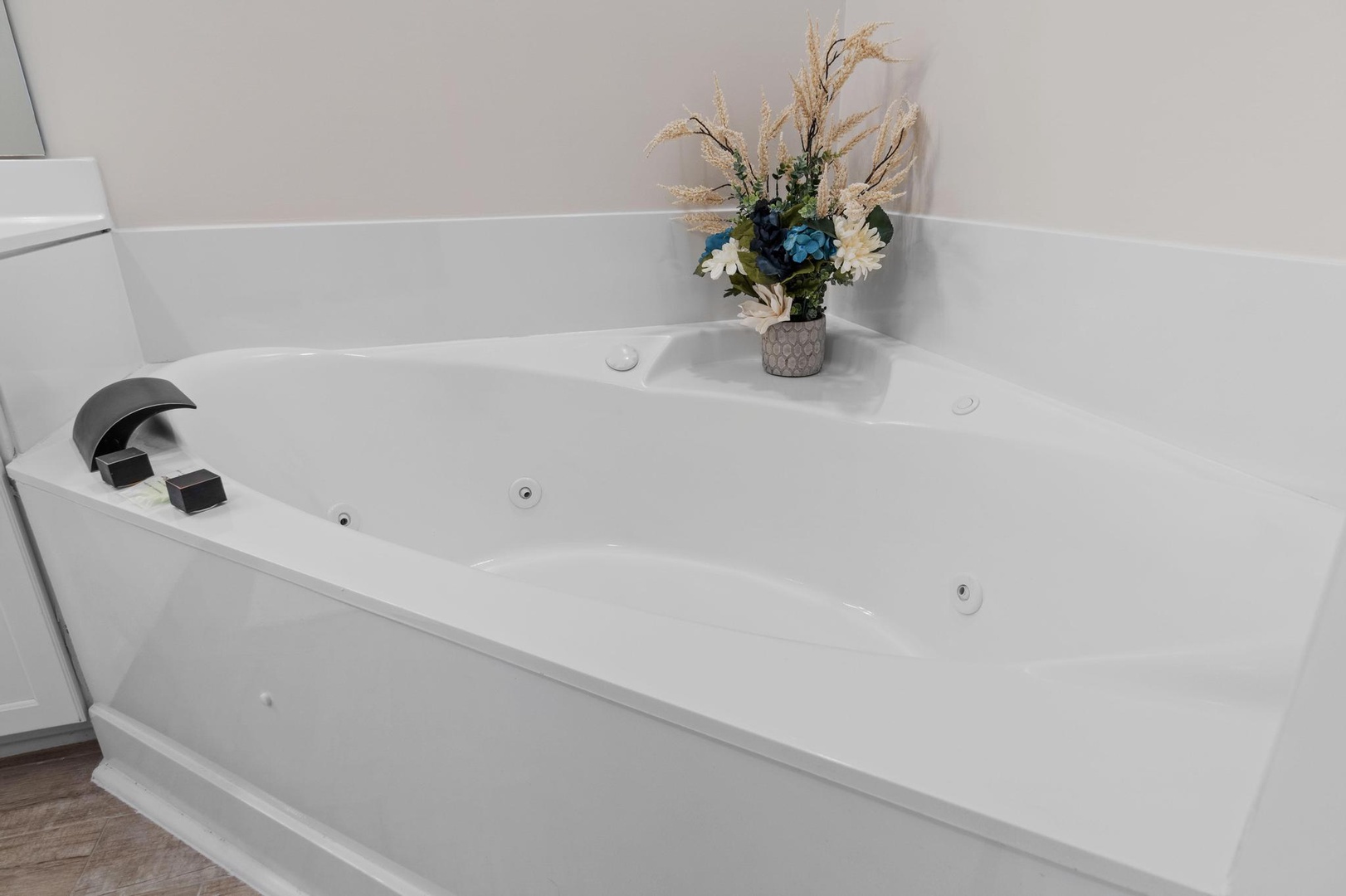 Master bathroom with custom double vanity and a large walk in shower and a jetted tub