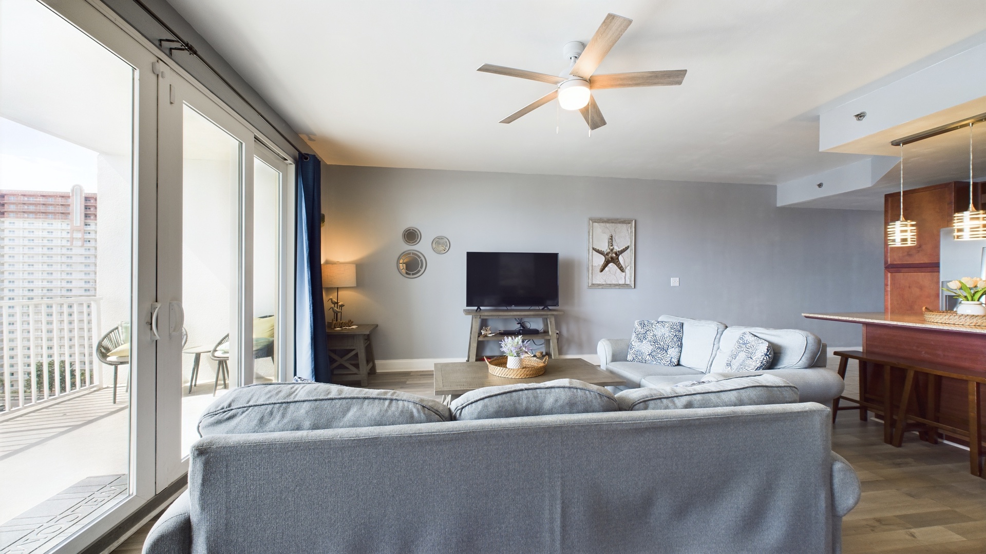 Open concept living area with TV coastal views and sleeper sofa