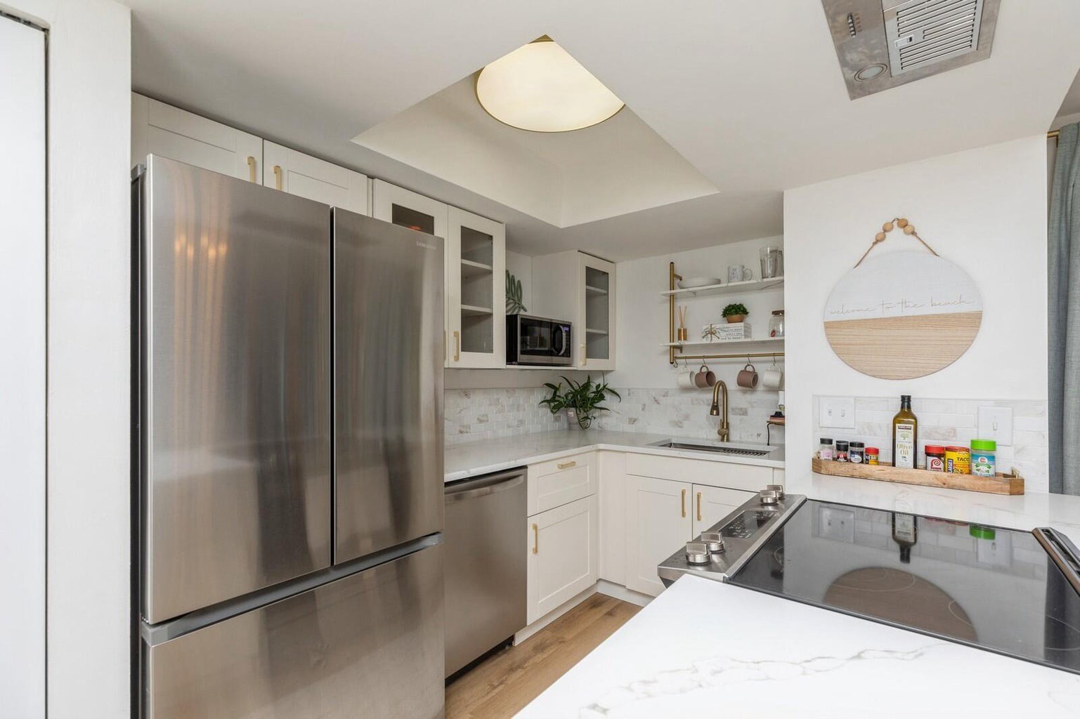 Updated stainless appliances with needed cooking supplies