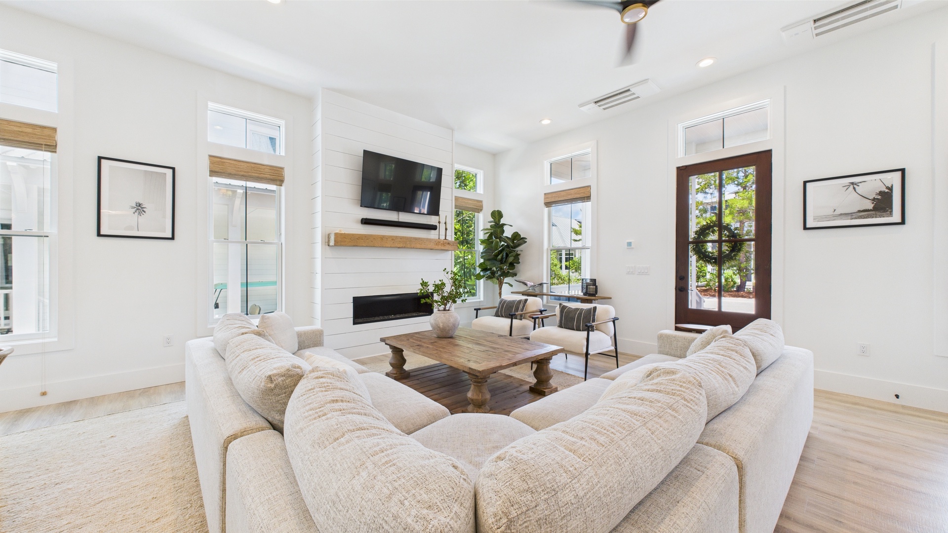 Open concept living area with stylish furnishings and huge TV