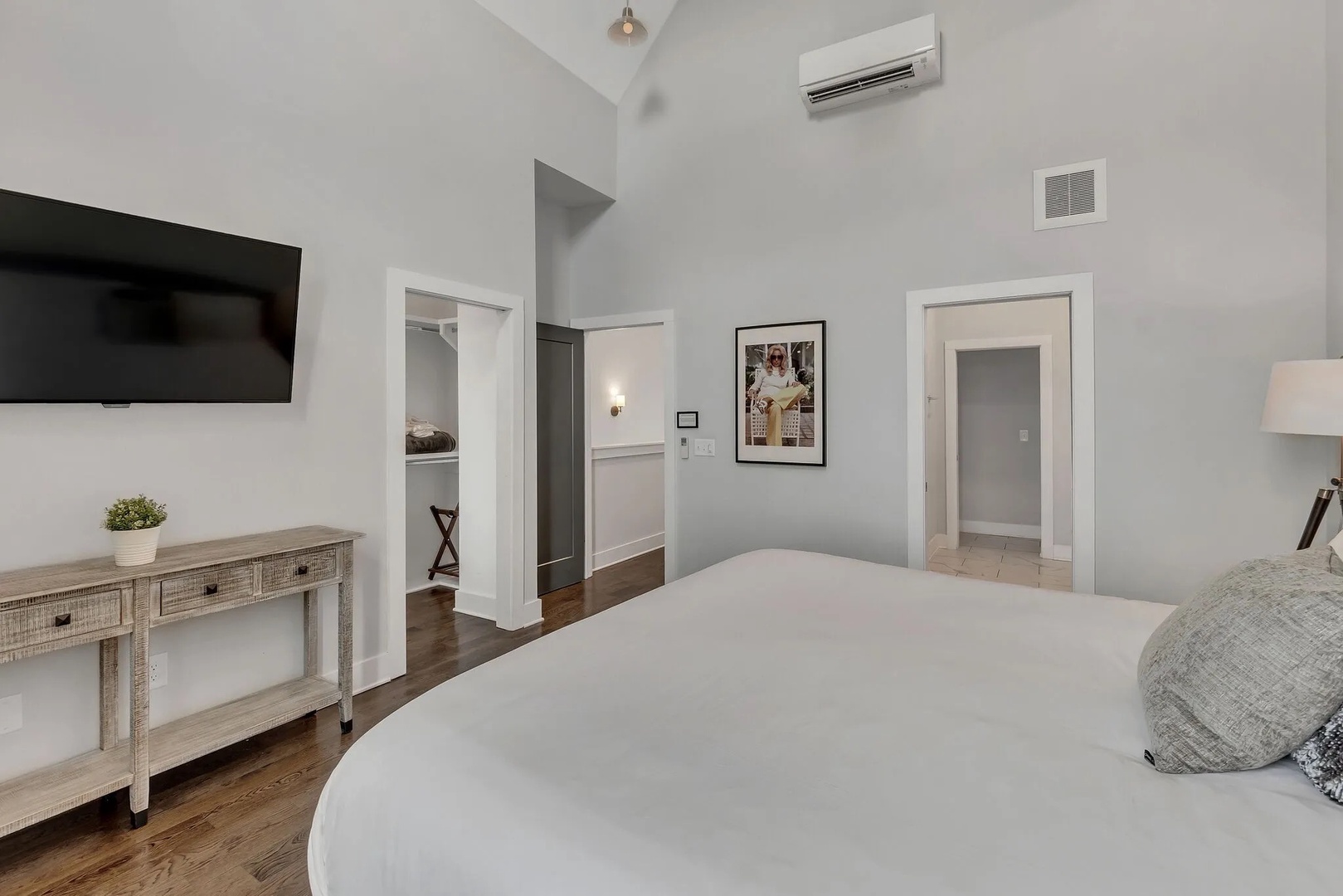 Primary bedroom with king bed TV and ensuite bathroom