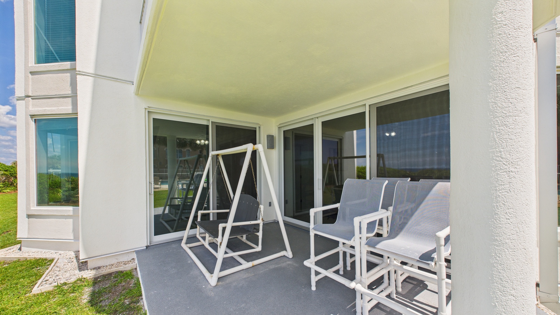 Stand-alone swinging bench and ample seating on patio