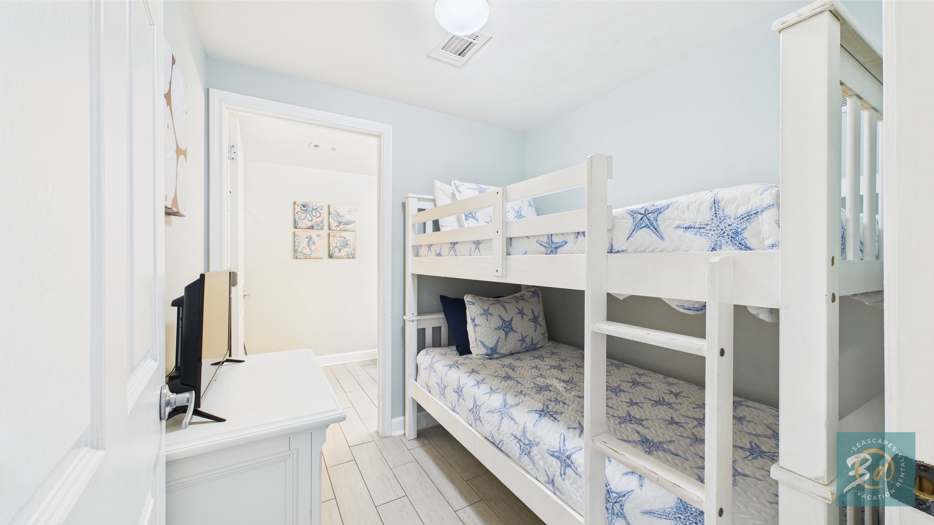 Bunk room with twin-over-twin beds in hallway and ensuite bathroom