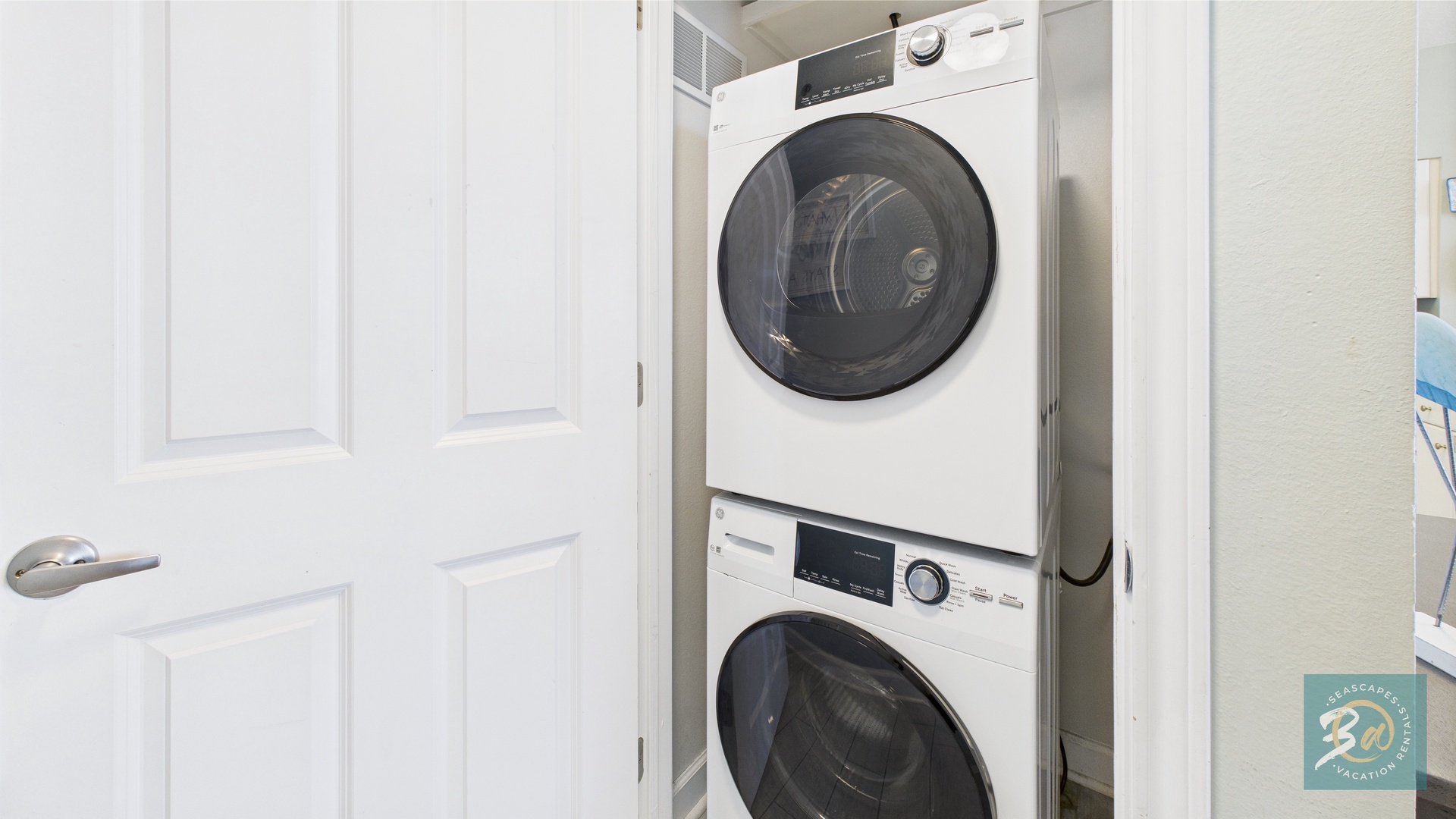 Washer and dryer machines in hallway closet