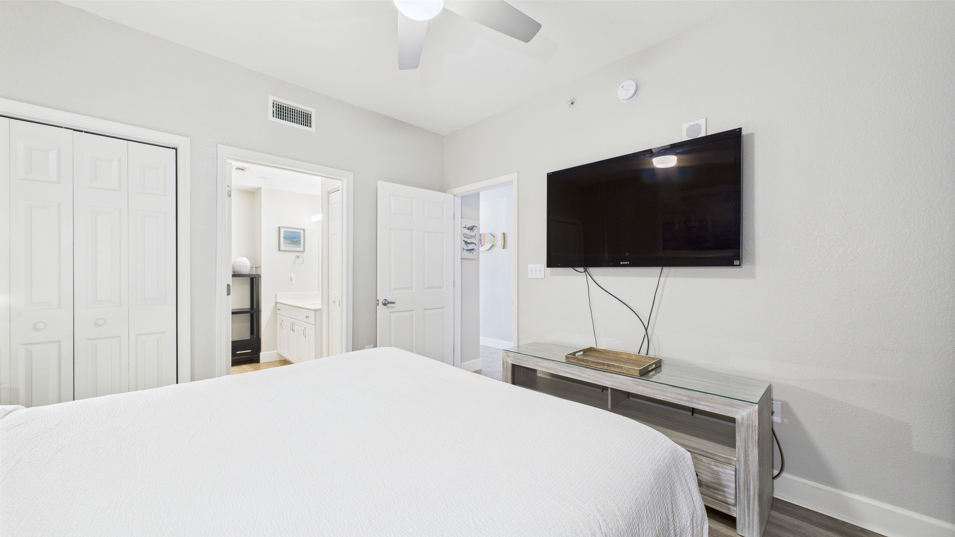 Master bedroom with king bed TV and ensuite bathroom