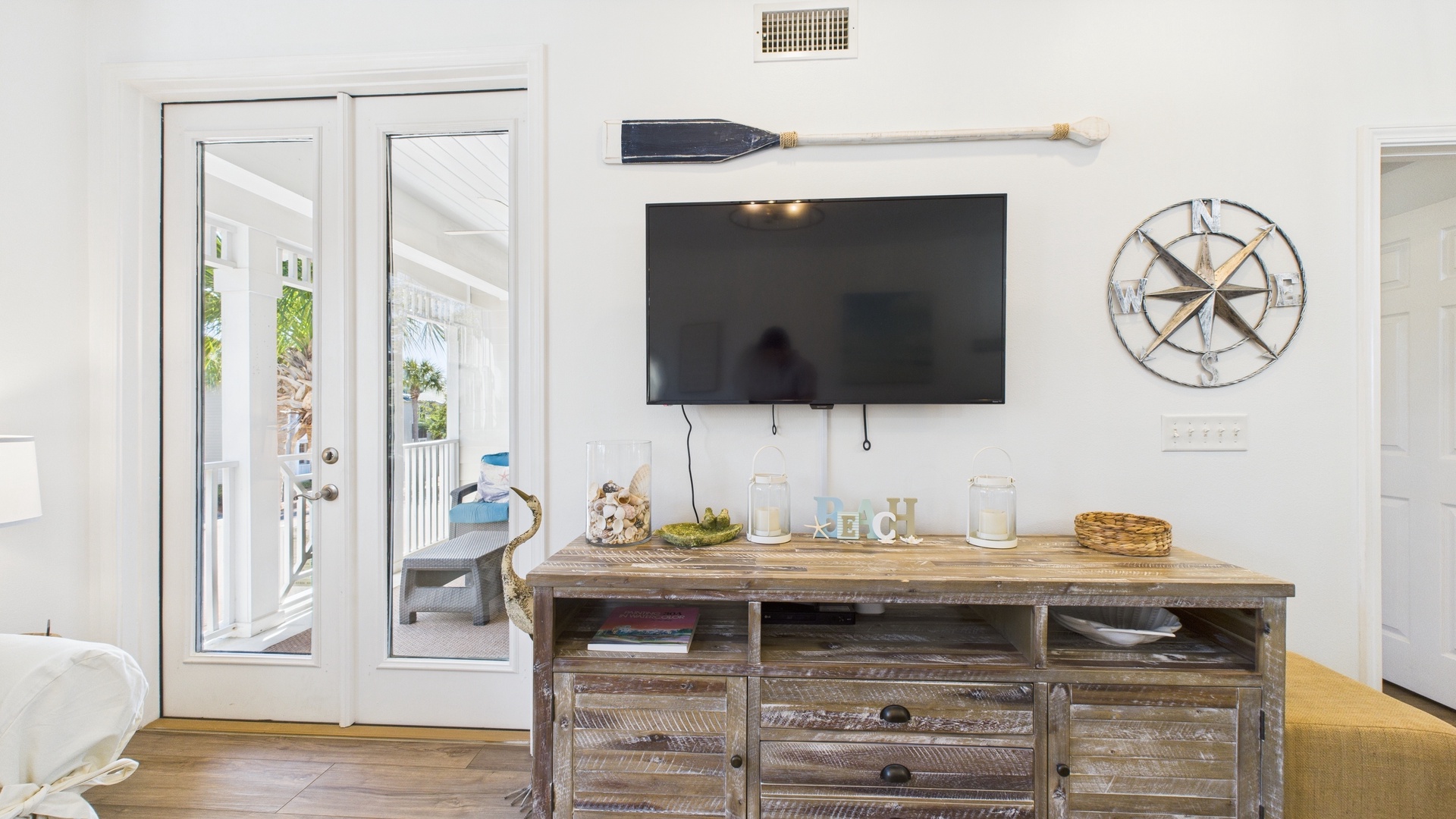 Open concept living area with TV and balcony access