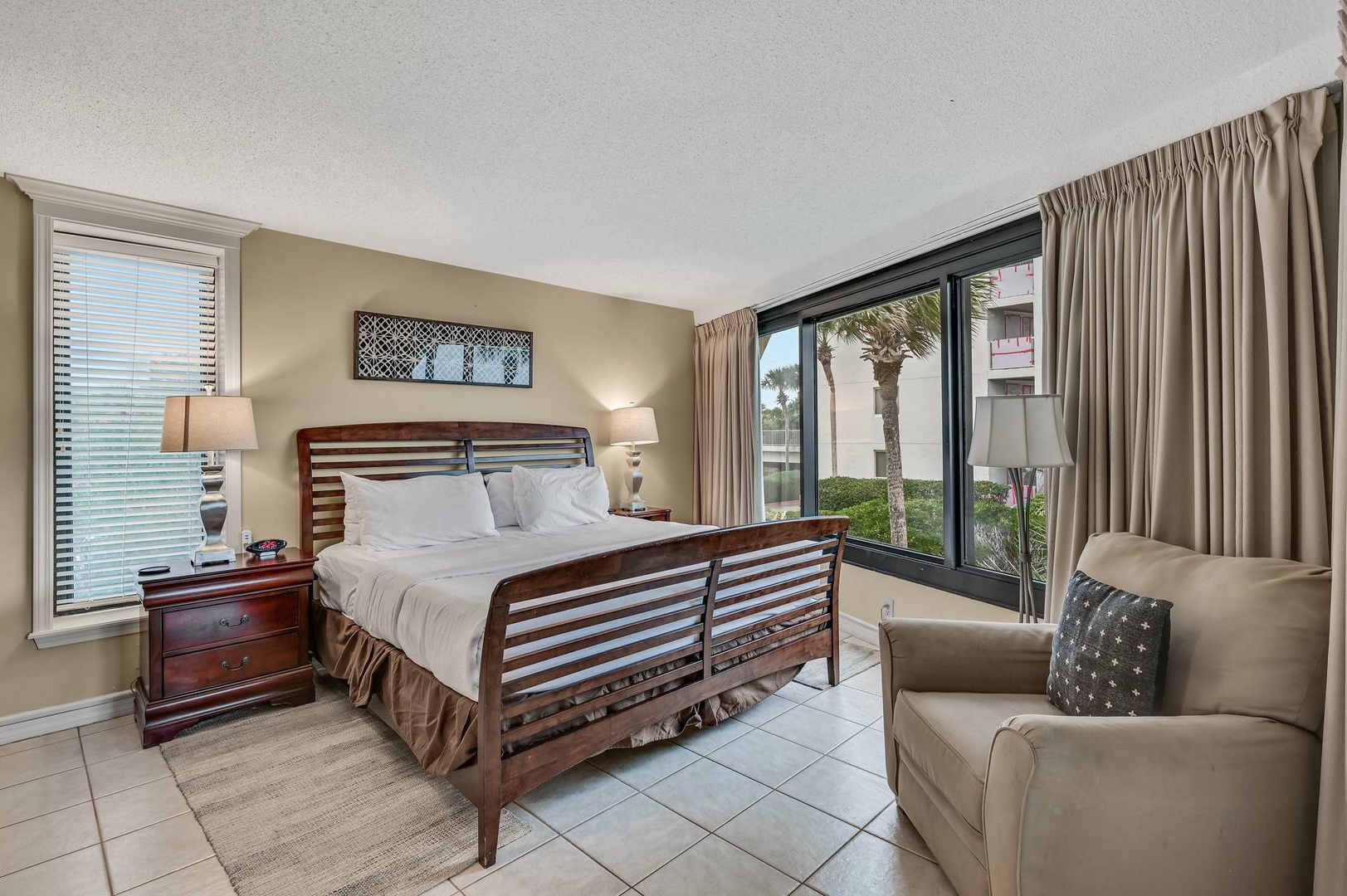 Primary bedroom with king bed TV balcony access and ensuite bathroom