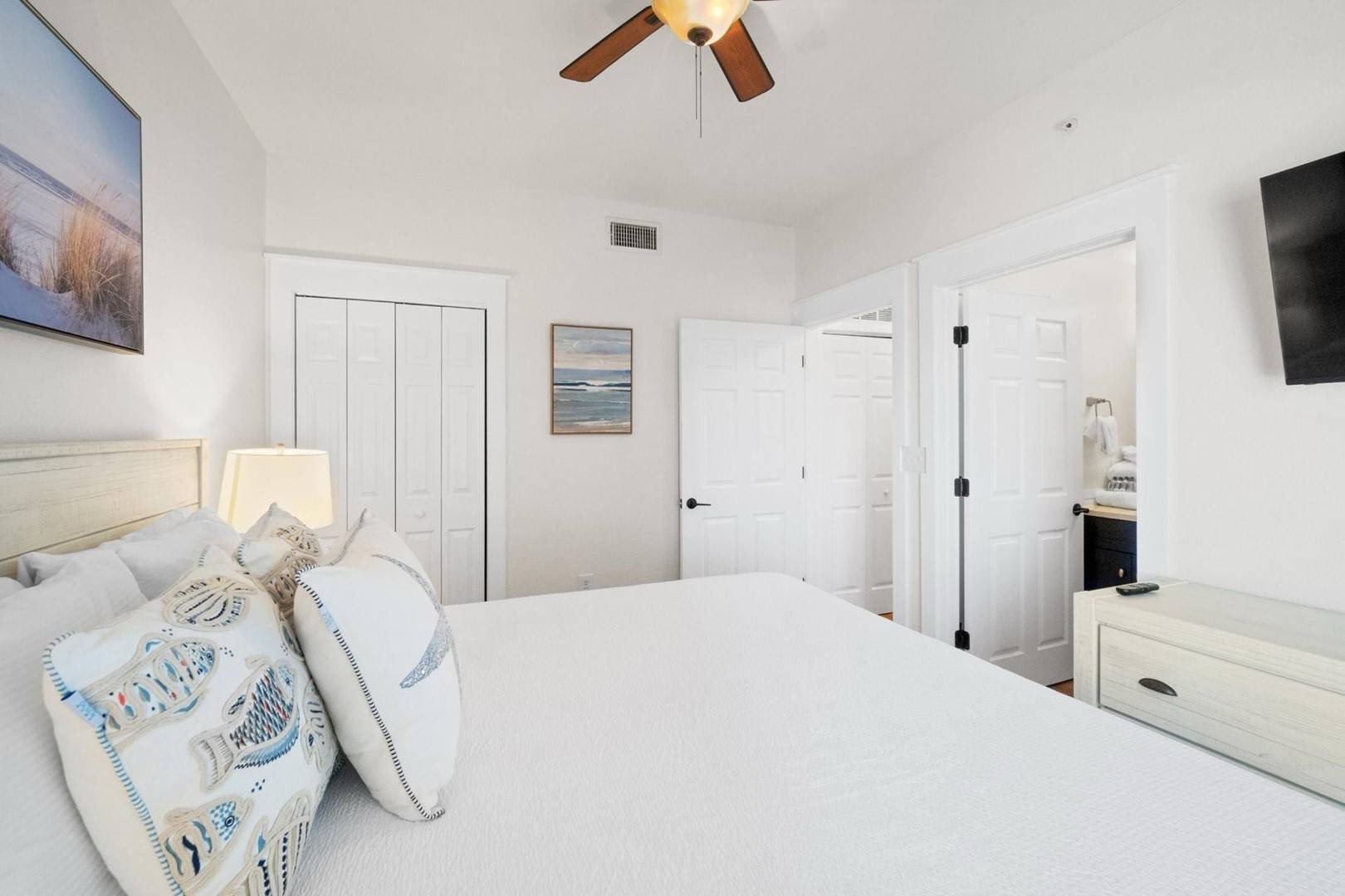 Master bedroom with king bed TV and ensuite bathroom