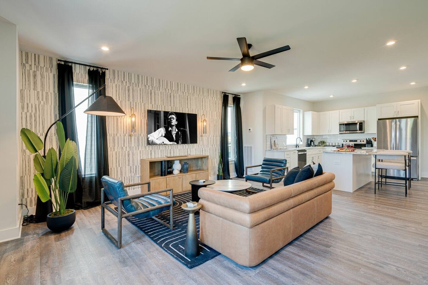 5627 - Open concept living area with stylish furnishings and smart TV.