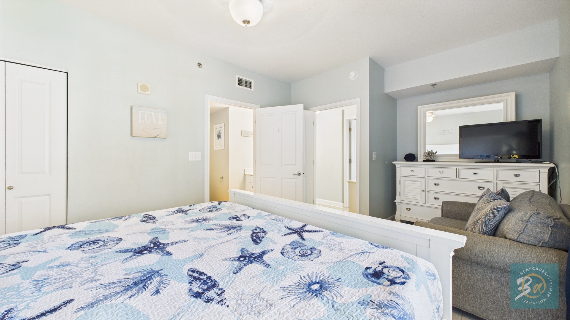 Master bedroom with king bed TV and ensuite bathroom