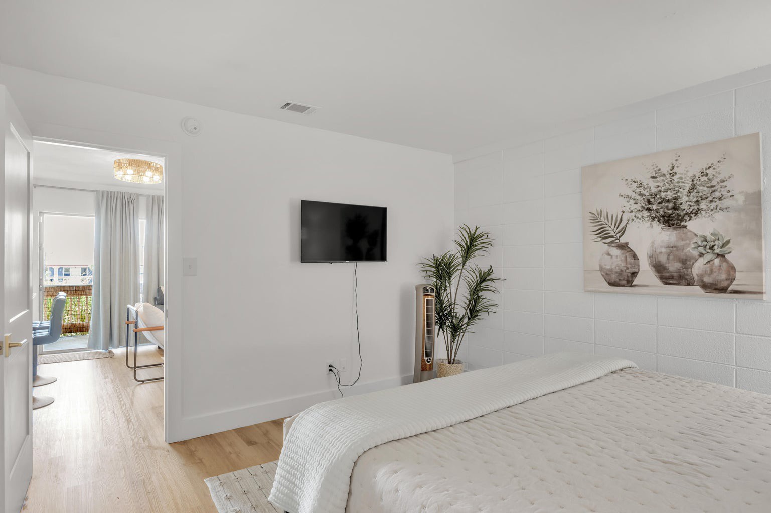 Master bedroom with king bed TV and ensuite bathroom
