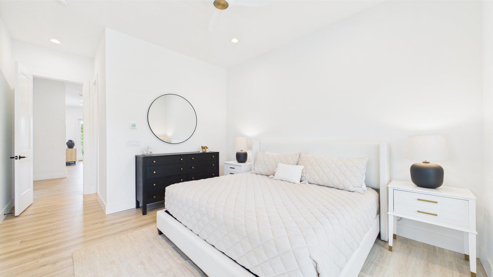Master bedroom with king bed TV and ensuite bathroom