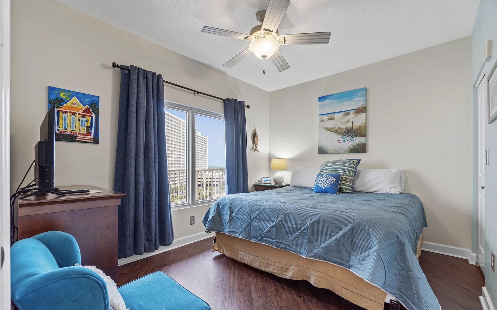 Second bedroom with king bed, TV, and scenic views.