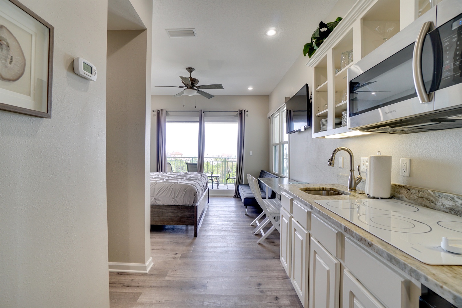 Kitchenette with cook top, fridge and microwave.