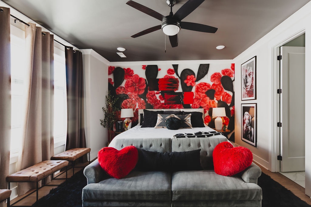 Primary bedroom with king bed TV and ensuite bathroom