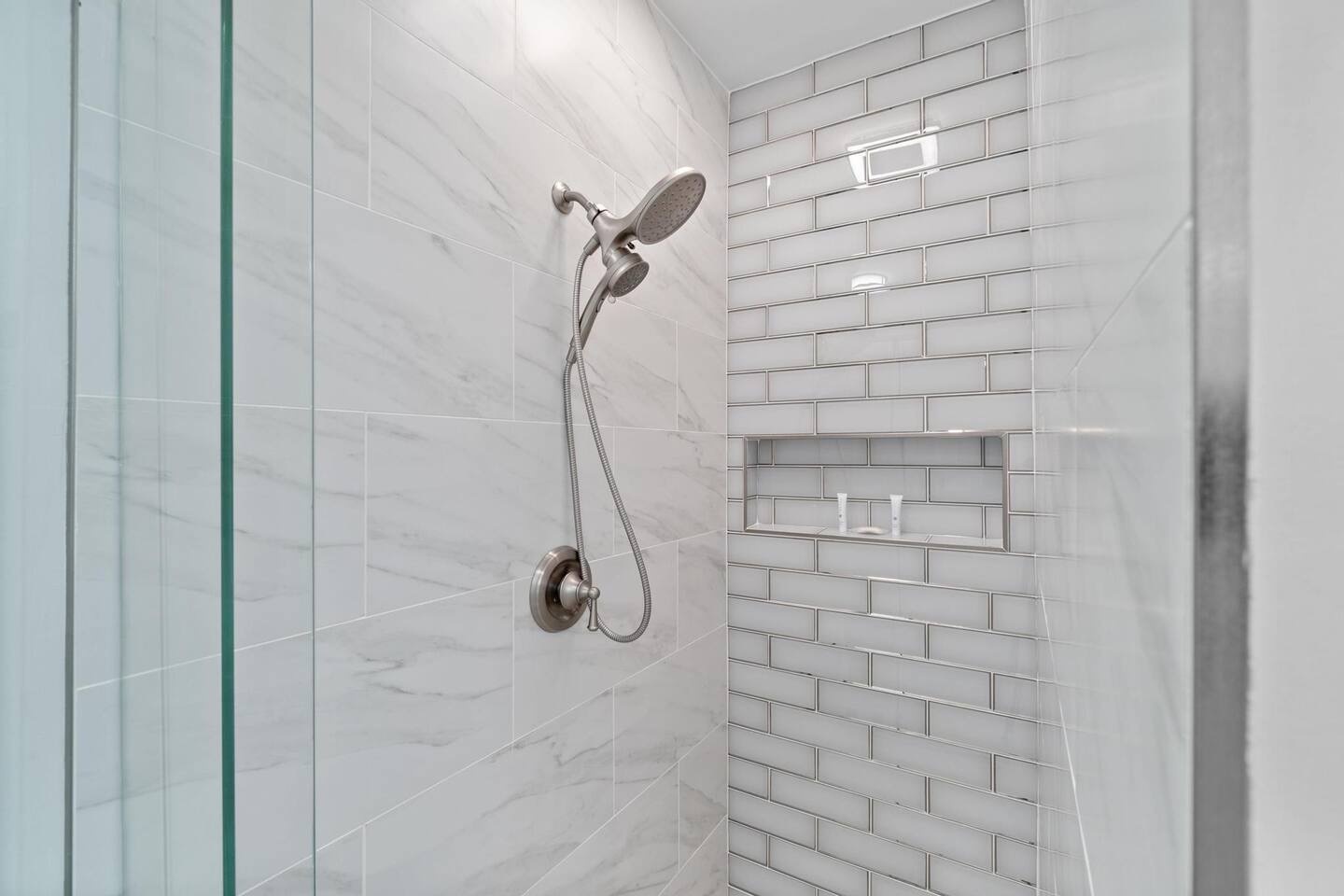 Primary bathroom with dual vanity bathtub and walk in shower