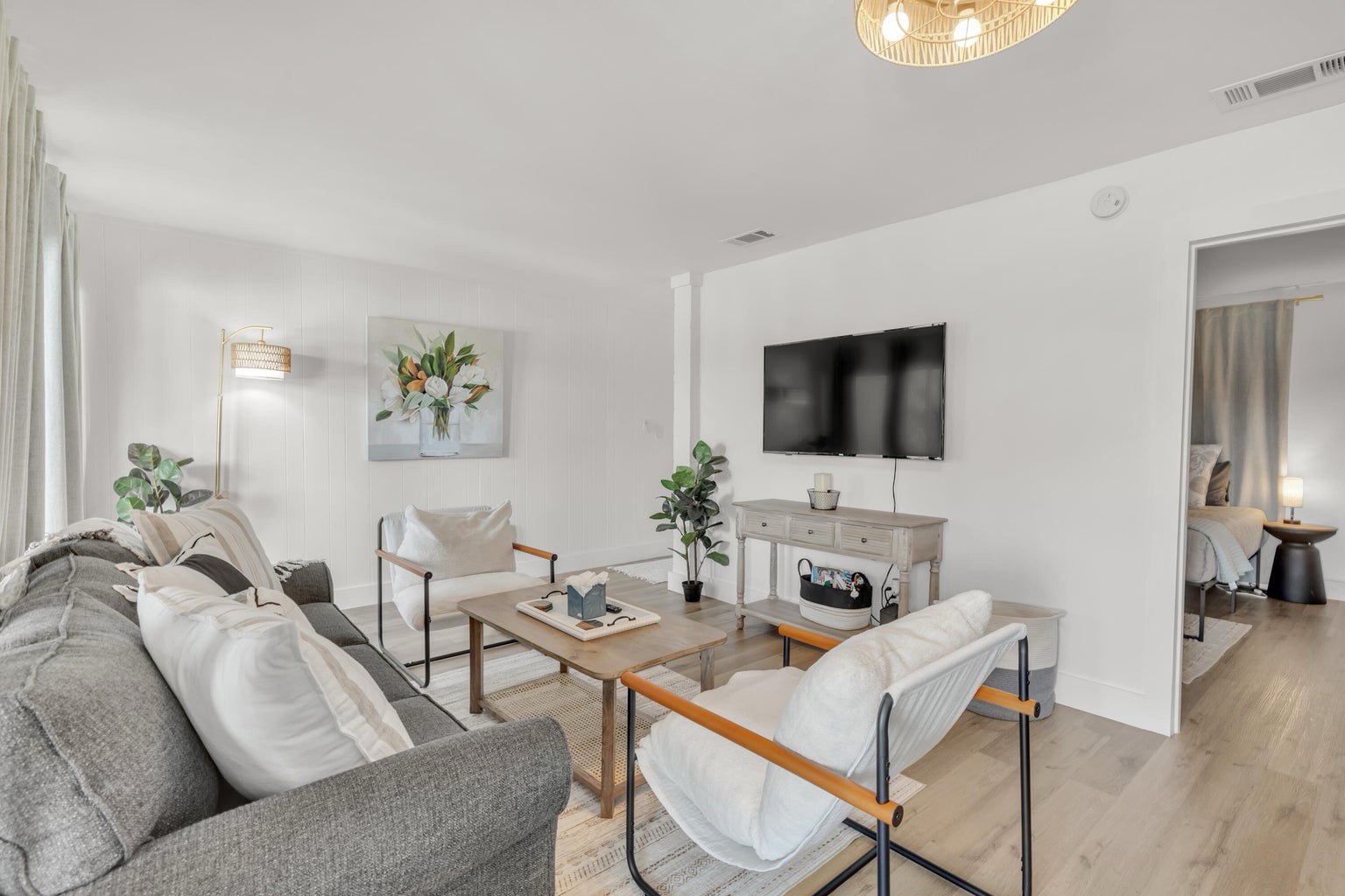 Open concept living area with stylish furnishings TV and pull out couch