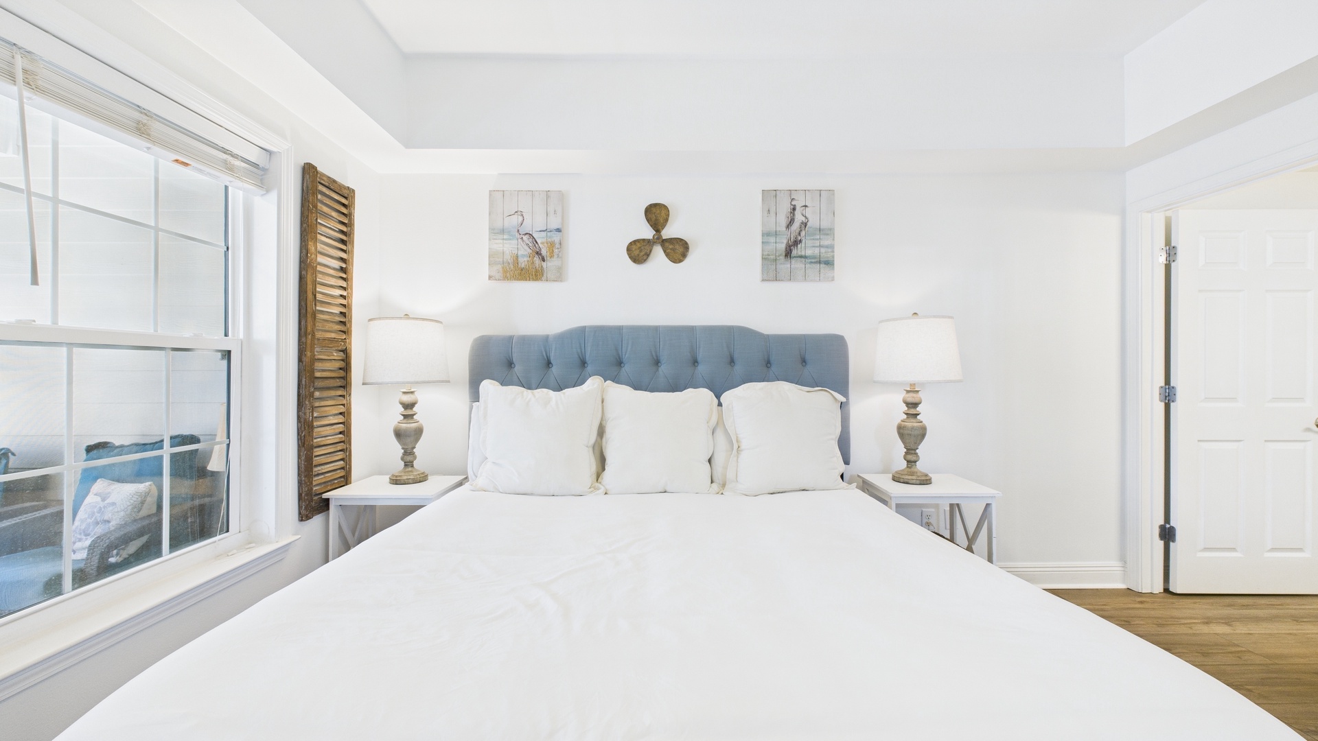 Primary bedroom with king bed TV and ensuite bathroom