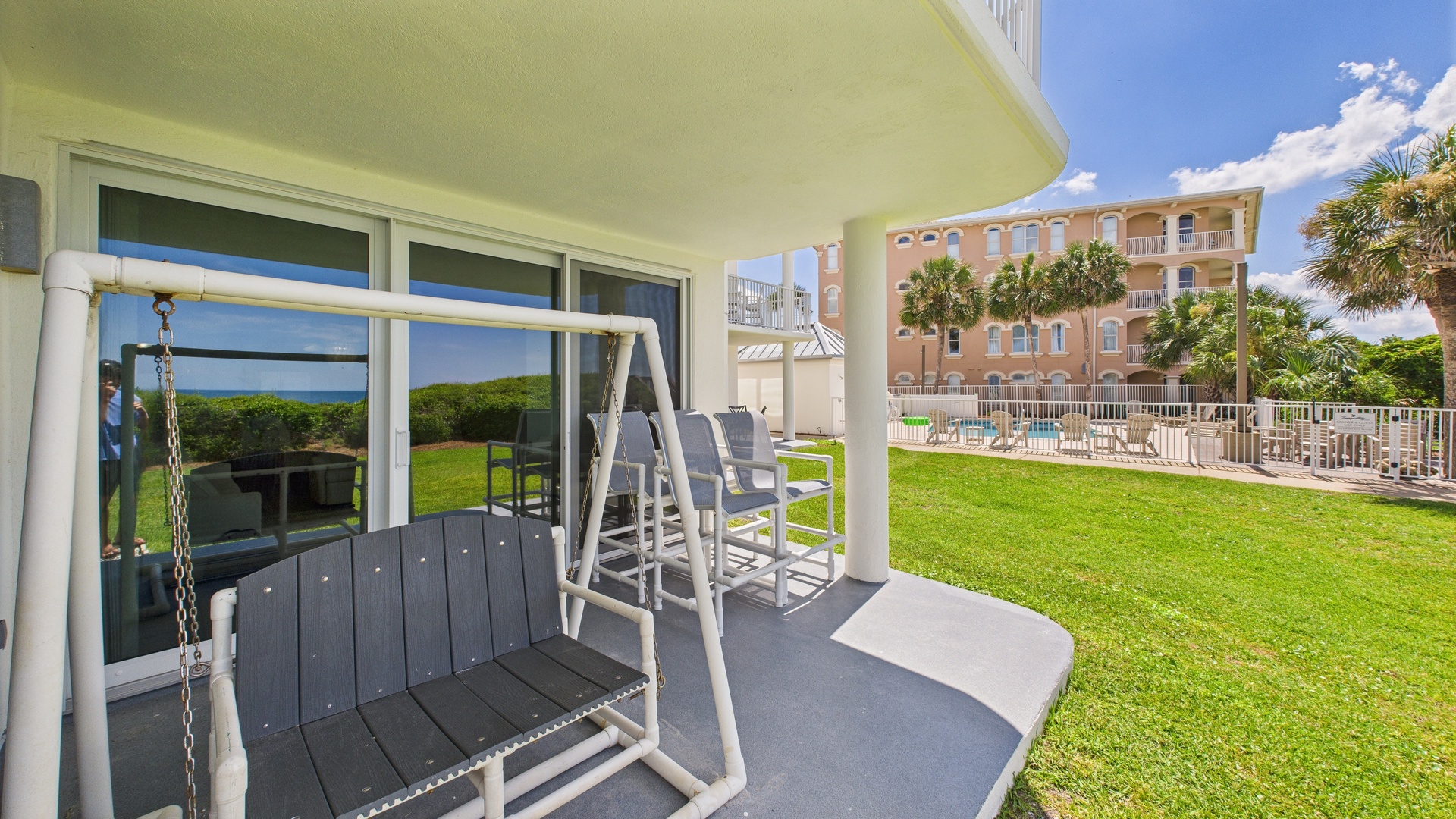 Stand-alone swinging bench and ample seating on patio