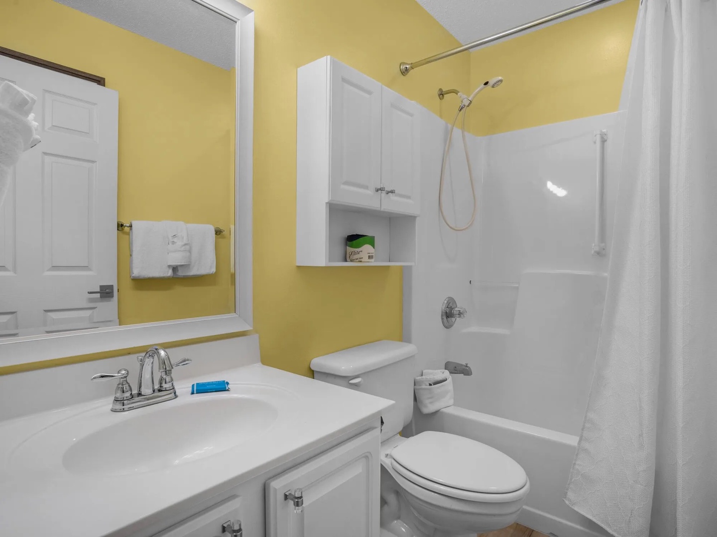 Second bathroom with shower and tub combo.