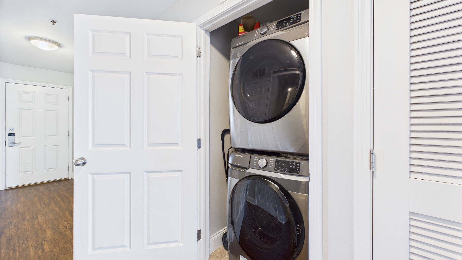 Washer and dryer machines in hallway closet