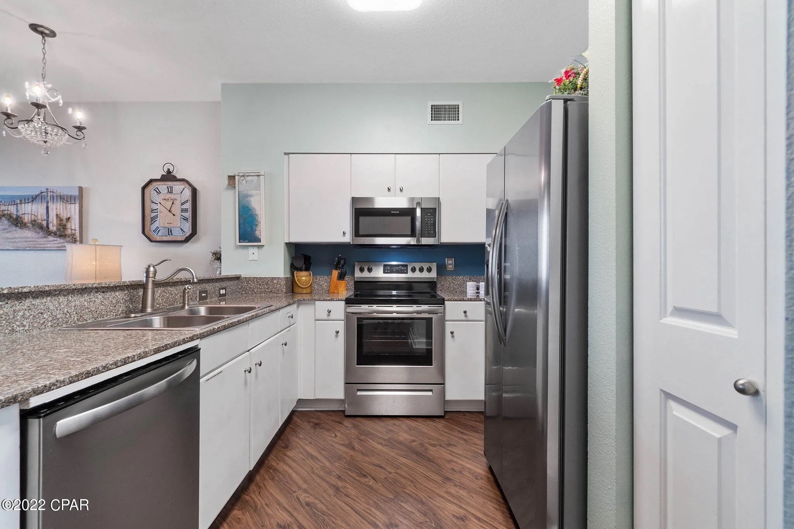 Full kitchen with stainless steel appliances and equipped with basic cooking essentials.
