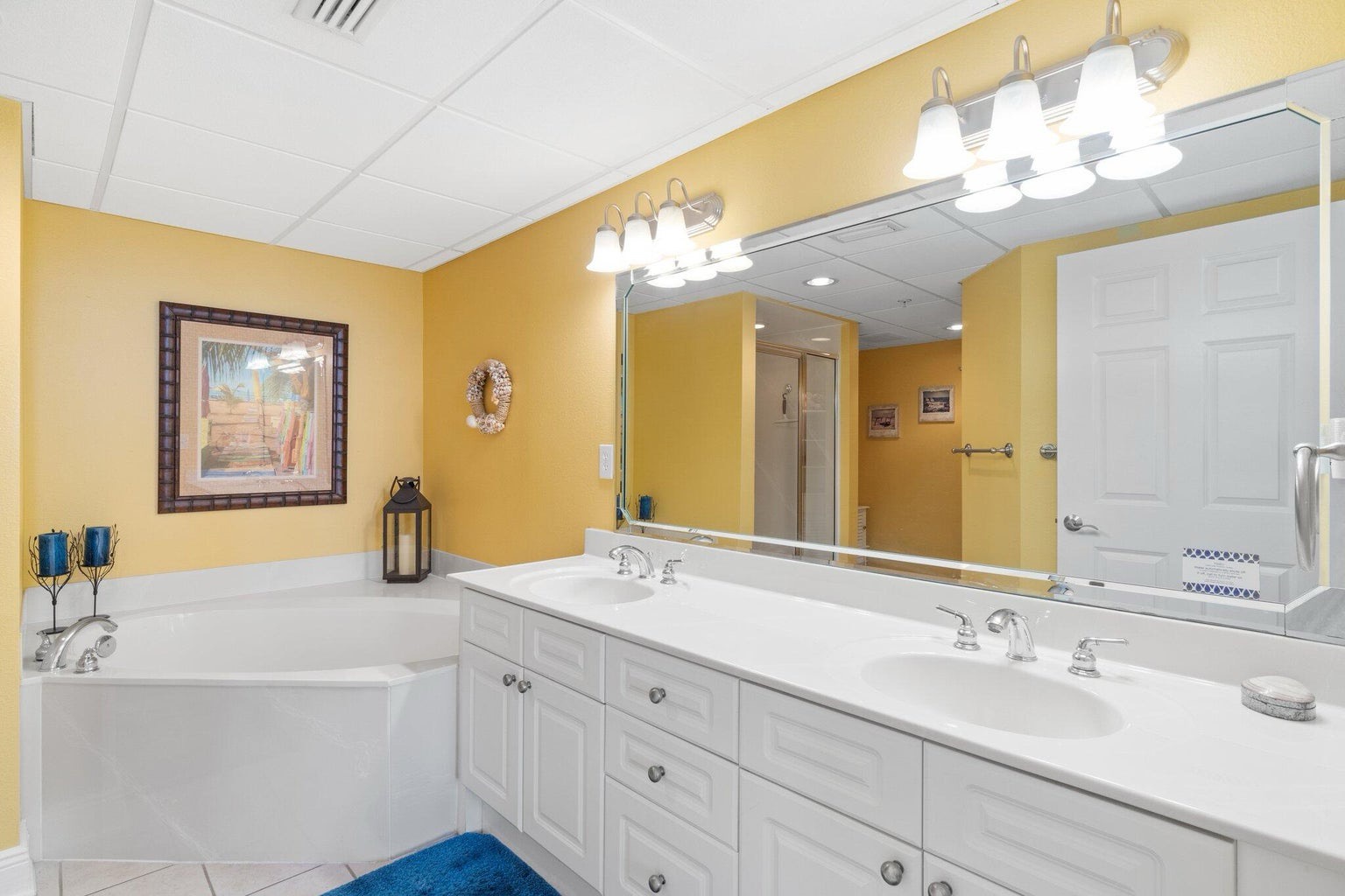Primary bathroom with dual vanity bathtub and walk in shower