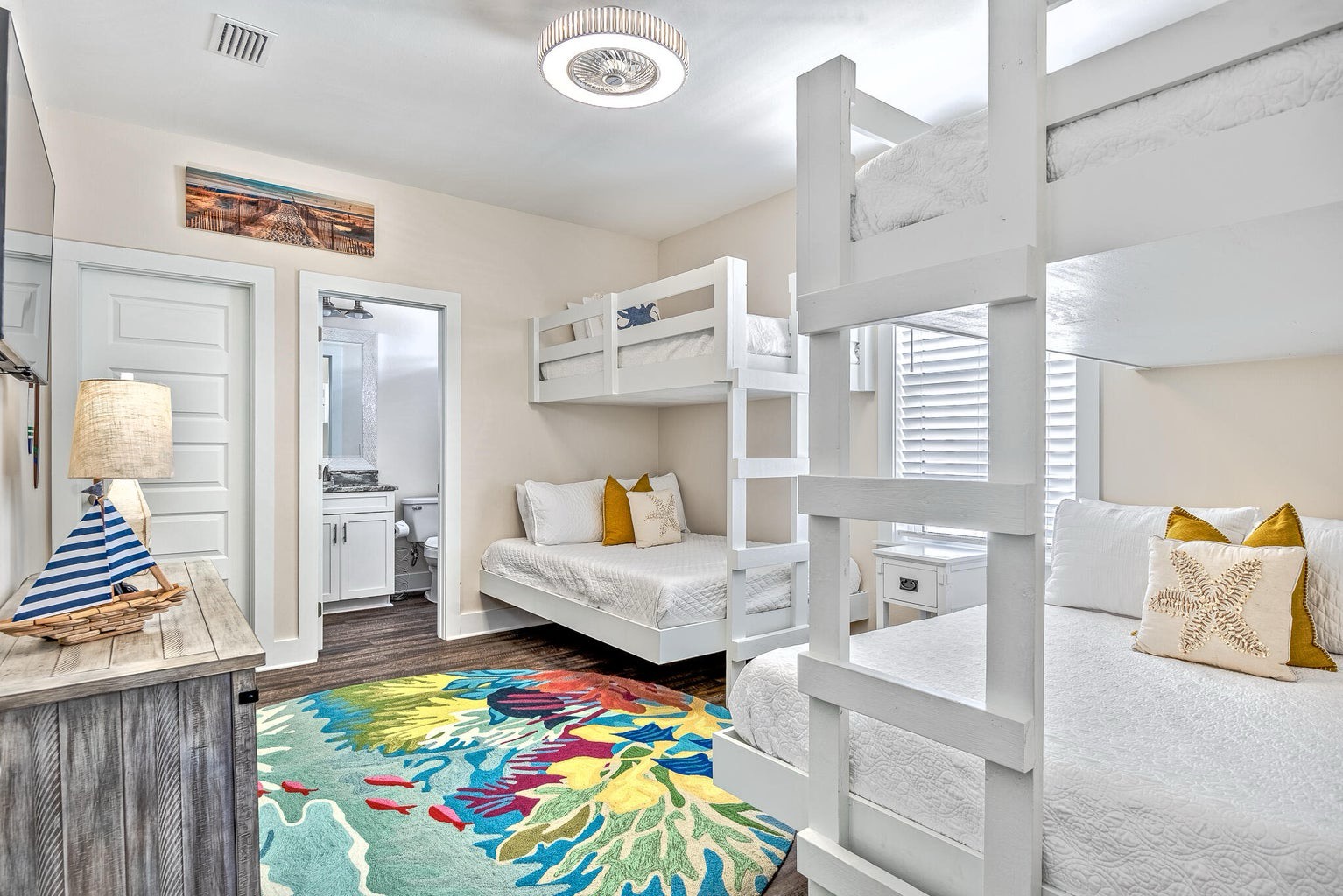 Bedroom with two twin-over-full bunks TV and ensuite bathroom