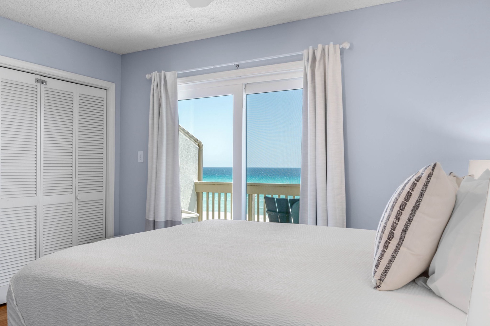 Master bedroom with queen bed & private balcony